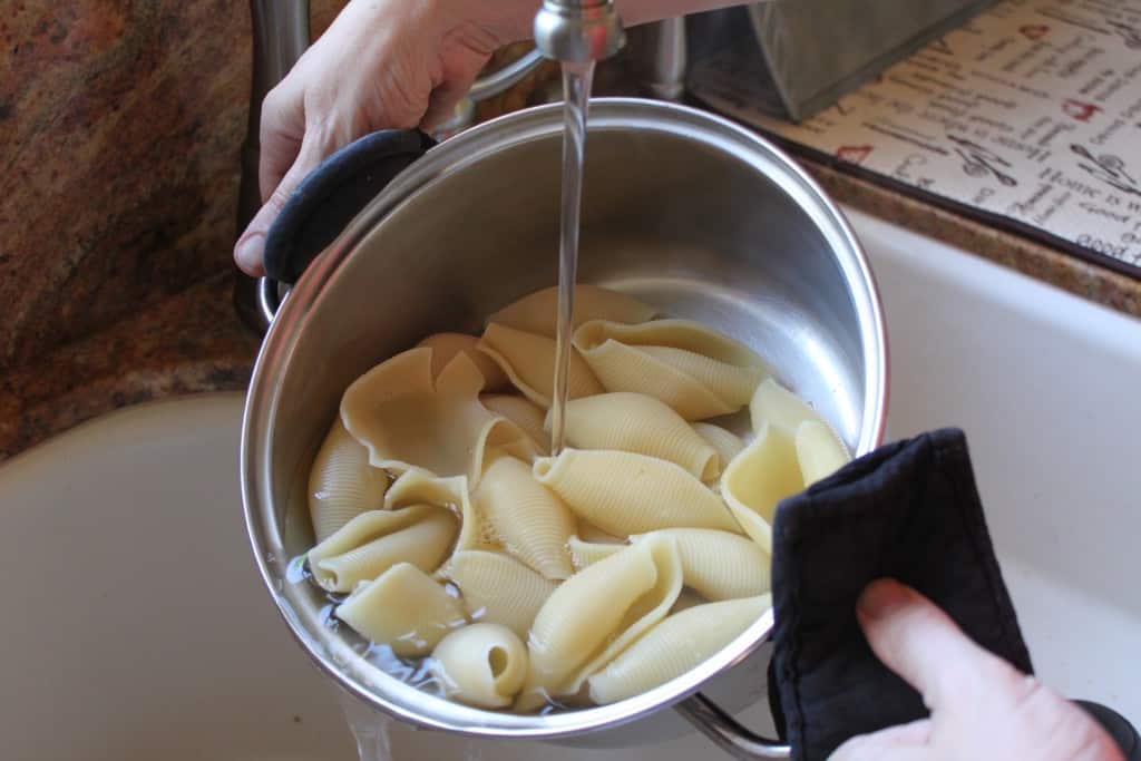 adding cold water to pasta shells