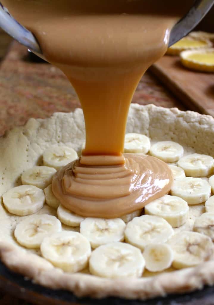 Pouring caramel into Banoffee Pie