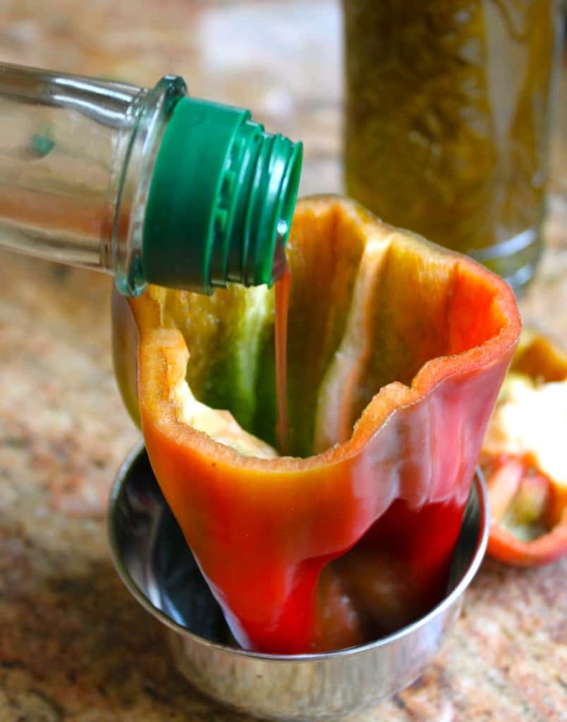 Pouring vinegar into pepper