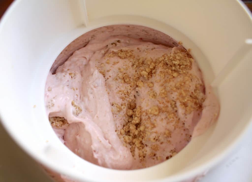 mixing crumble into rhubarb ice cream