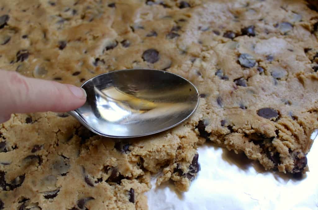 pressing dough into pan with a spoon