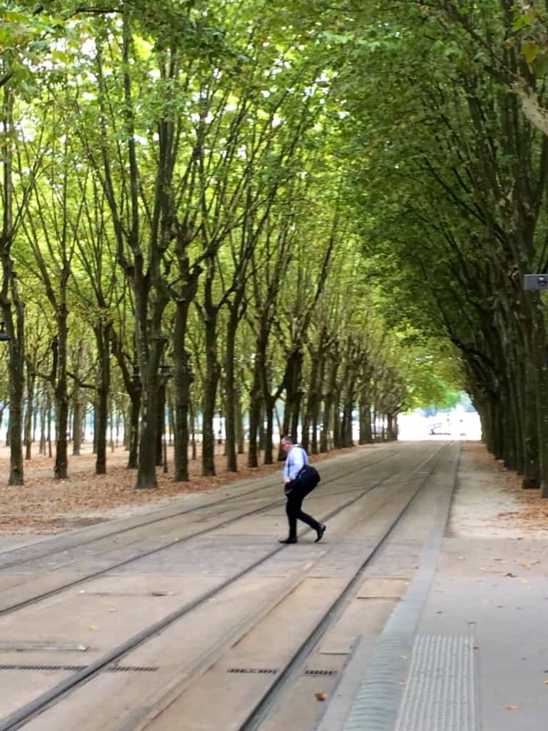 man walking across tracks in Bordeaux