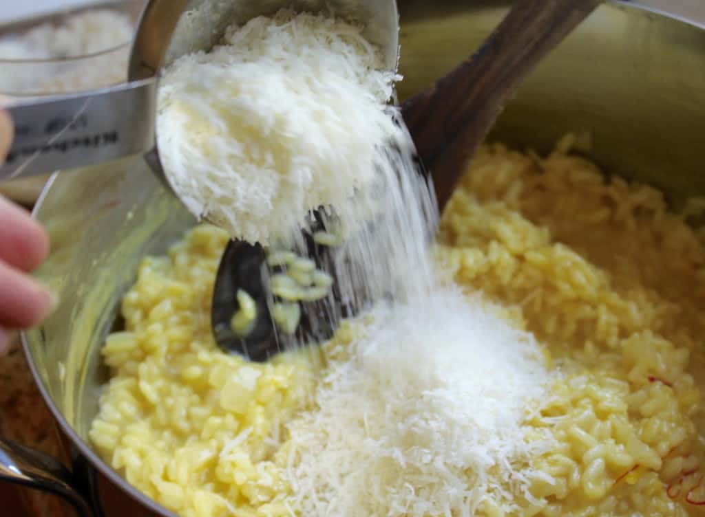 Adding Parmesan to Risotto alla Milanese recipe