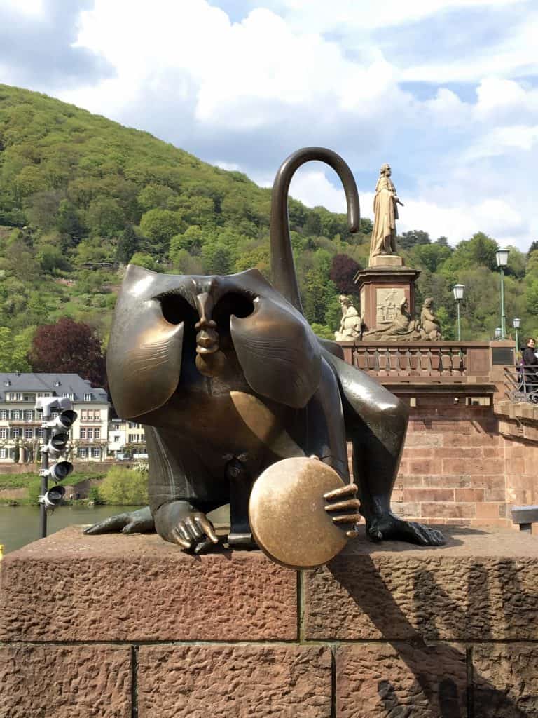 Bridge monkey in Heidelberg, holding a mirror.