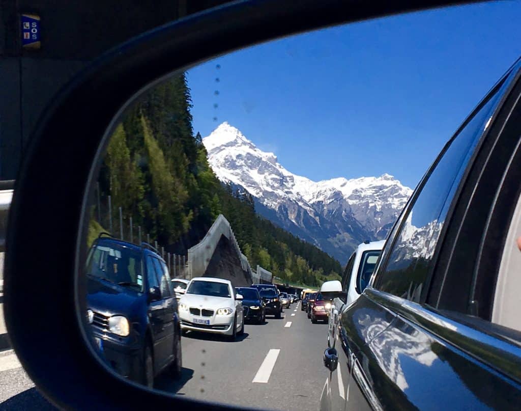 Swiss Alps in my rearview mirror driving from Switzerland to the Italian Lakes