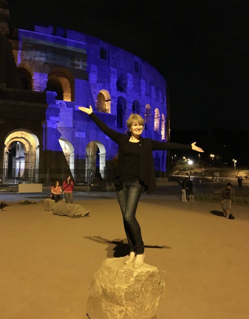 Christina of Christina's Cucina in front of the Colosseum finding cheap airfare