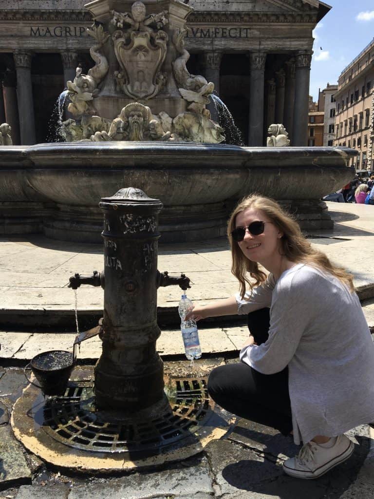 Filling an empty water bottle on a trip to Rome