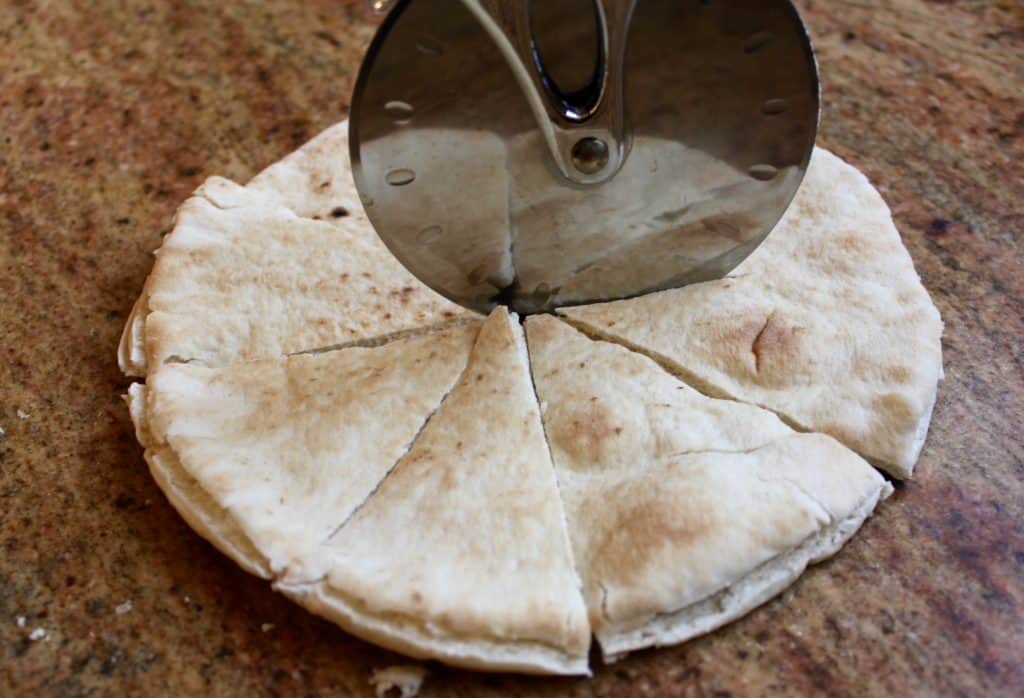 Cutting pita bread to make chips