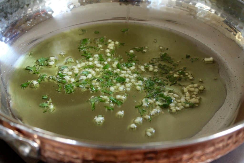 Cooking parsley and garlic in a Lagostina skillet.