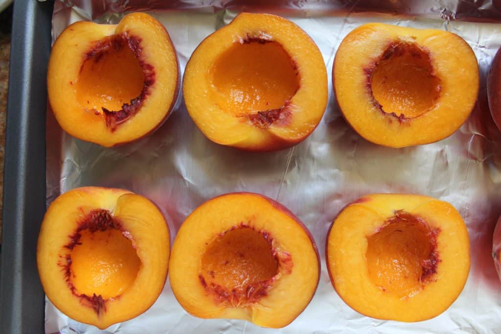 halves of peaches ready to be filled