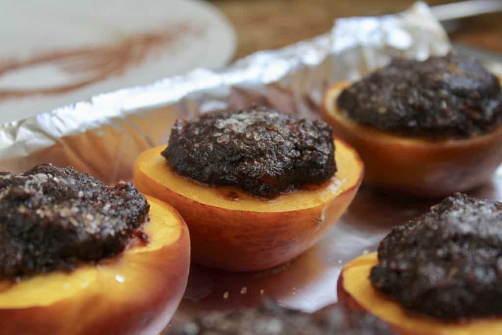 Italian style baked peaches filled with cocoa and biscuits ready to bake