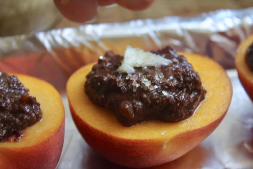 Italian style baked peaches filled with cocoa and biscuits ready for the oven