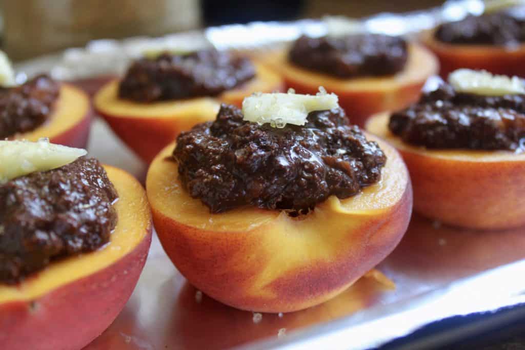 Italian style baked peaches filled with cocoa and biscuits ready for the oven