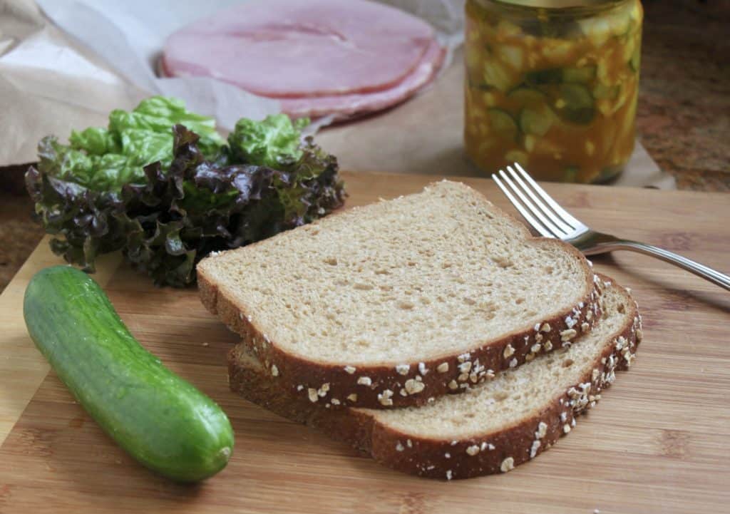making a Ham piccalilli and cucumber sandwich