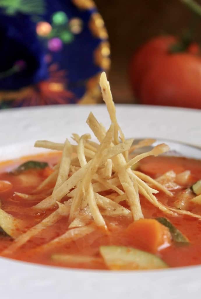 tortilla soup with crunchy tortilla strips in bowl