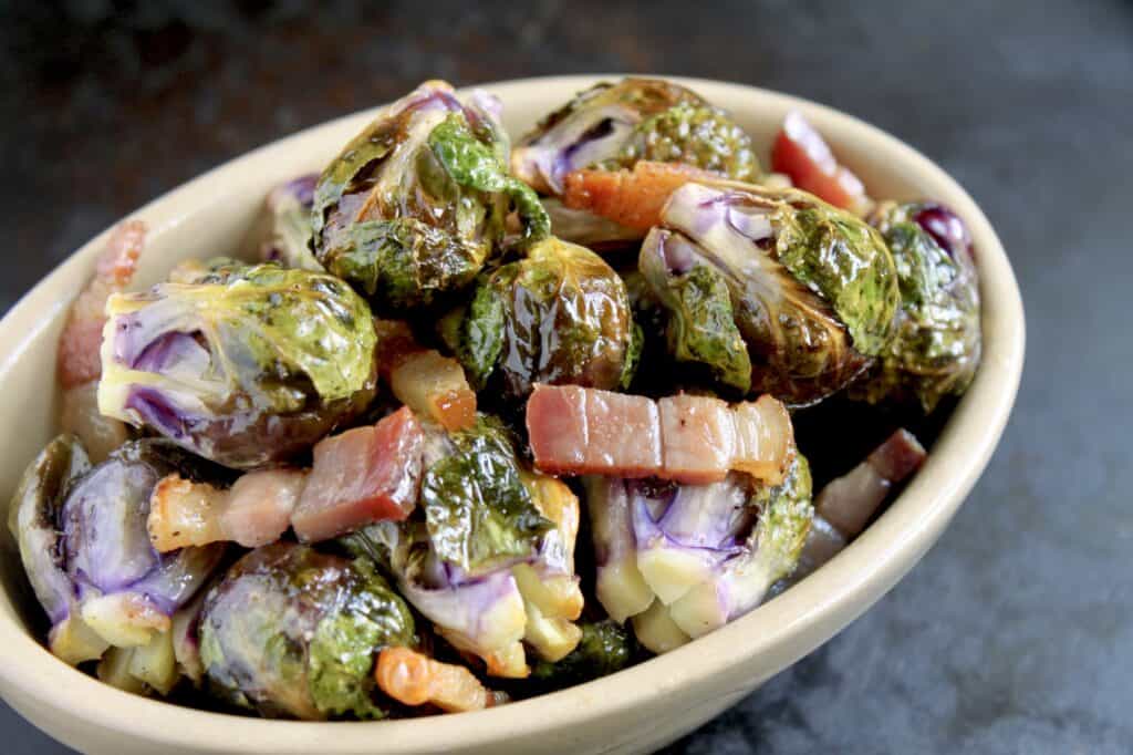 roasted brussel sprouts with pancetta in an oval dish