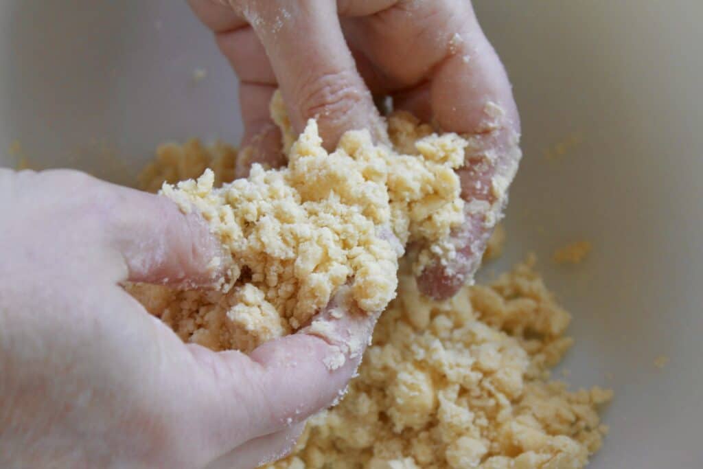 rubbing flour and butter together to make the crumble topping recipe