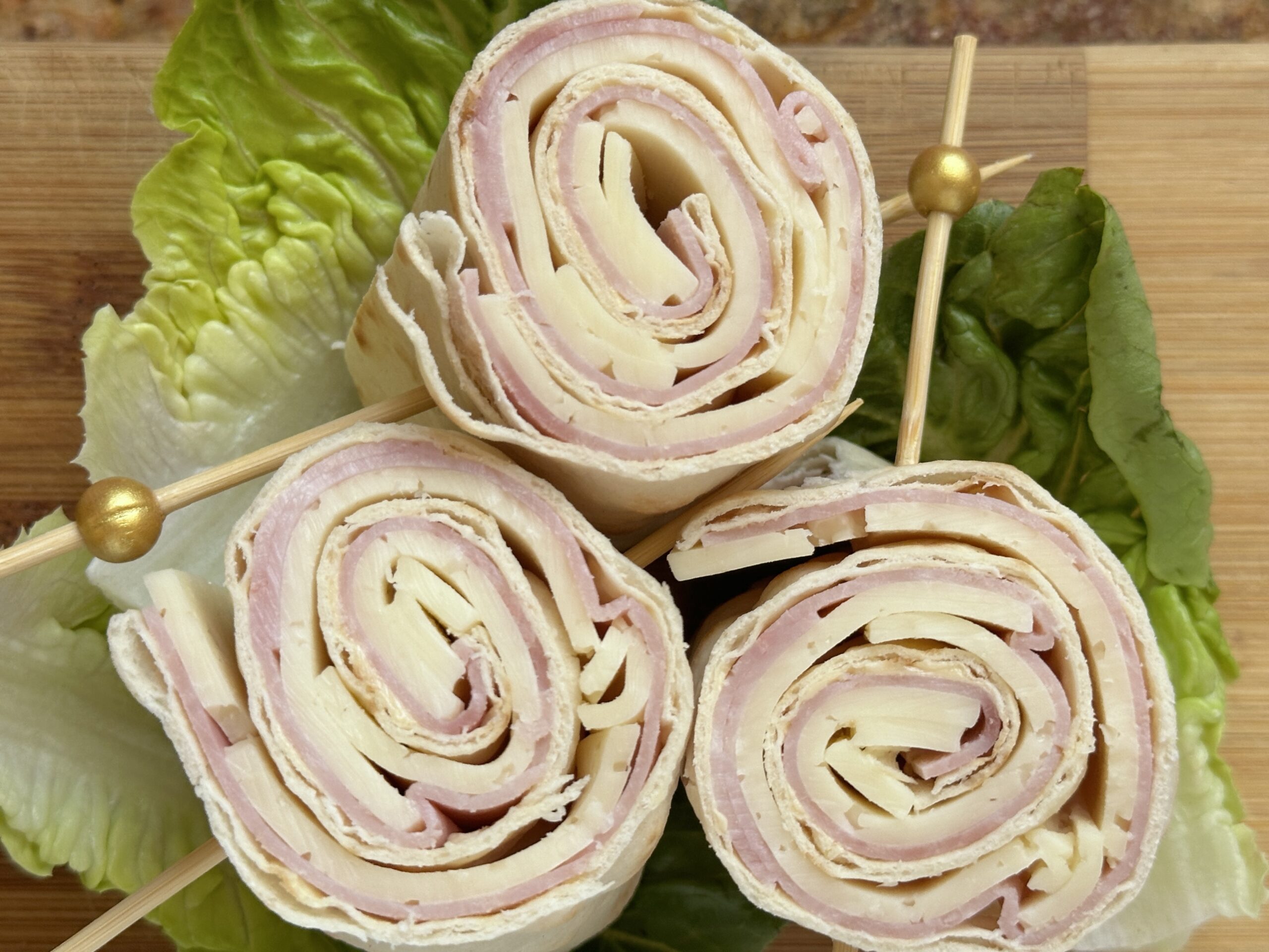 ham and cheese pinwheels on lettuce