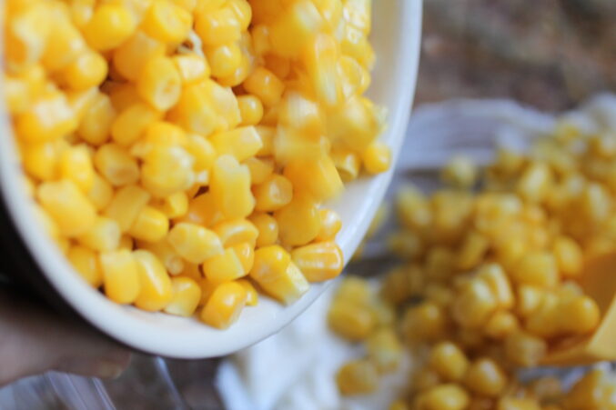 putting corn in a bowl