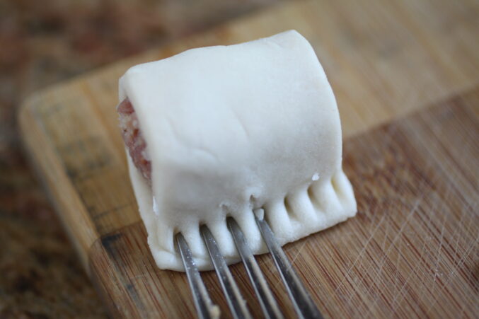 crimping the edge of the pastry to seal