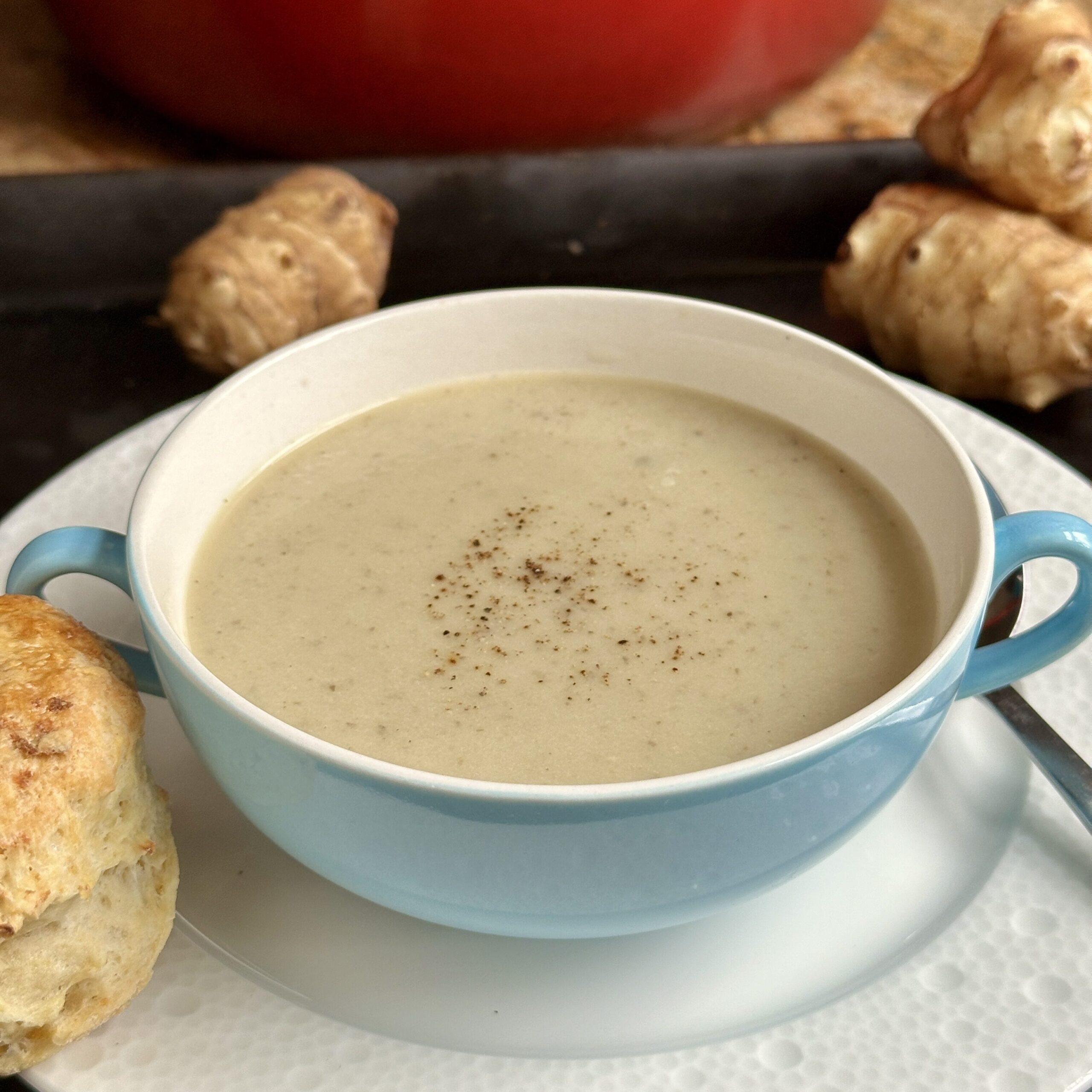 sunchoke soup with scone on plate