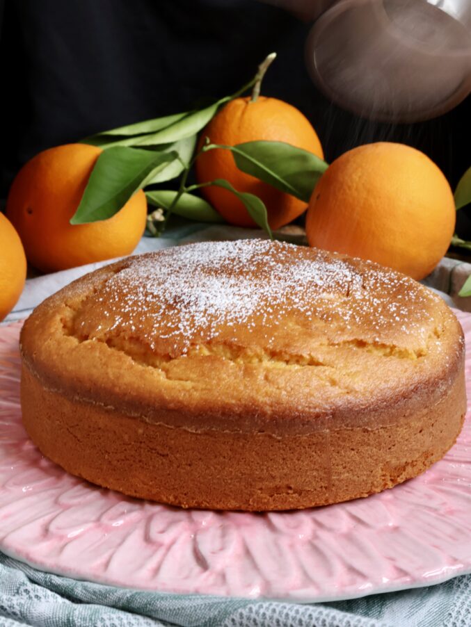 dusting orange cake with powdered sugar 